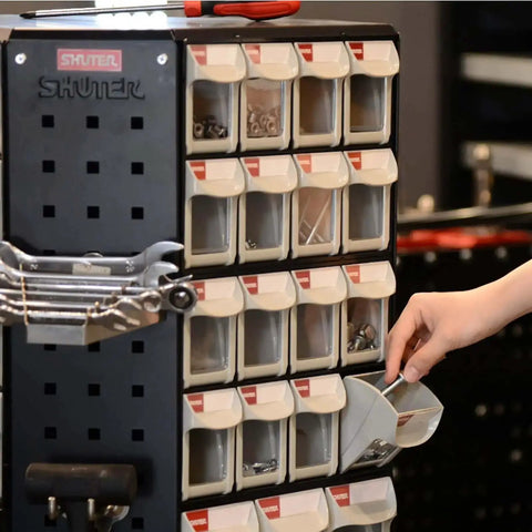 Person using stackable eight drawer tool organizer with tilt out drawers for small parts, workshop and garage cabinet, black.