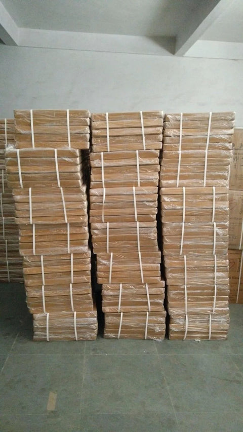 Ceramic fiber insulation boards, tan color, stacked in three wrapped bundles with white straps.