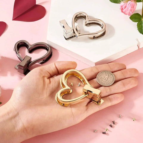 Dope Heart Purse Twist Lock Closures Set For Bags 3 Pack In Black Light Gold And Platinum Metal Turn Lock Fasteners displayed on hand