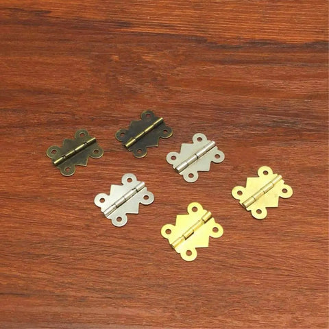 Miniature Butterfly Hinge Set For Dollhouses And Tiny Boxes Gold Silver Bronze 29mm X 27mm 10Pcs Or 20Pcs on wood surface