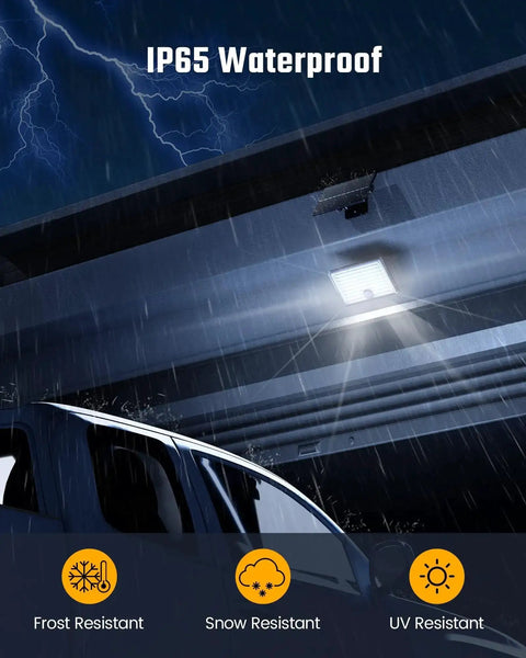 Mini Solar Flood Lights Outdoor With Motion Sensor illuminating a driveway in rain, IP65 Waterproof, highlighting frost, snow, UV resistance.