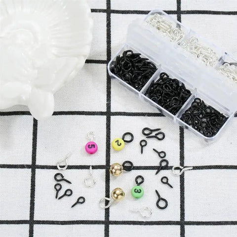 Must Have 300Pcs Small Screw Eye Pins For Jewelry Making And DIY Crafts in silver and black with bead and charm accessories on grid background