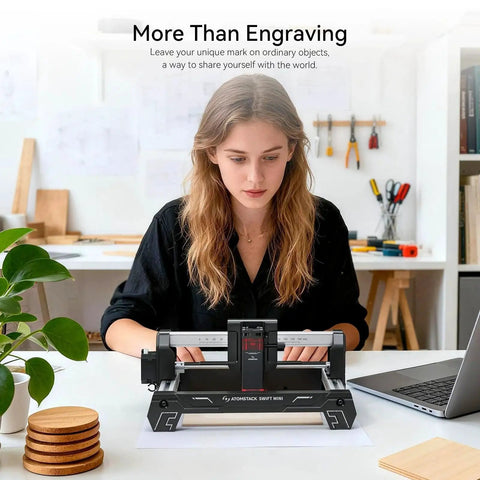 Swift Laser Engraver For Beginners 3W Desktop Cutter With 135x145mm Work Area And 0.04mm High Precision For Wood Leather Acrylic Crafts Gifts 3000mW Fully Pre Assembled No Tool Setup Ready From Atomstack on a table in use by a person