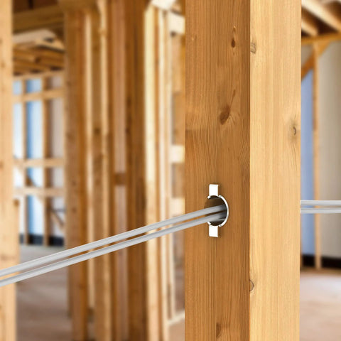 FOROIRON nail guard for electrical wiring installed in a wooden stud; white circular guard surrounding three gray cables.