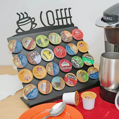 Space Saving K Cup Pod Holder For Countertop Holds 24 Coffee Pods In A Sleek Black Metal Display Stand Durable And Grab And Go Coffee Organizer Rack For K Cups showcasing full capacity of pods near a coffee maker.