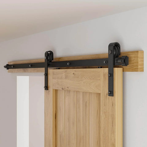 Close-up of a 5 Foot Sliding Barn Door Hardware Kit For 26 To 30 Inch Wide Single Door Matte Black Track System With J Shape Rollers.