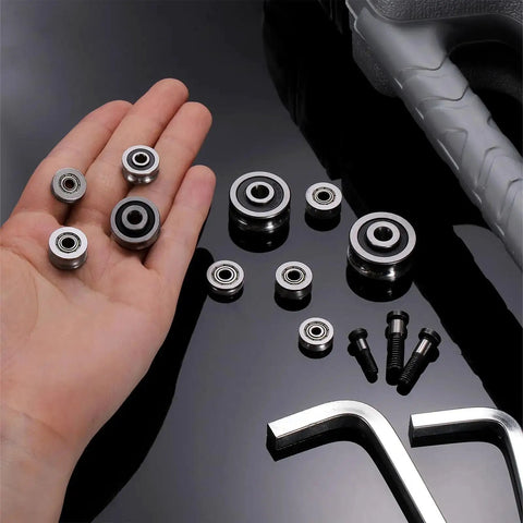 Hand holding 12 Pack Small U Groove Pulley Bearings 4x13x4mm For Rail Track Linear Motion Systems, with tools visible.