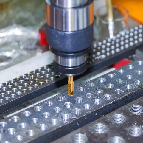 Close-up of Spiral Point Tap 5 By 16 By 18 UNC B2 Accuracy Titanium Coated Pro Grade 6542 High Speed Steel in metalworking machine