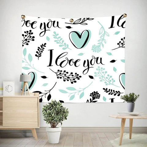 Wall tapestry with 'I love you' message, teal heart and floral design, decorated with brass fasteners in a modern room setting.