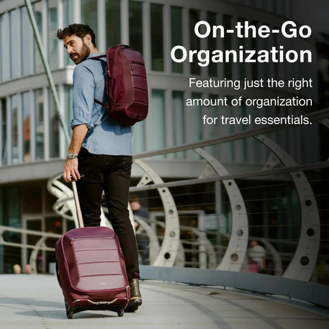 Man with backpack and Ozone 2-Wheel Carry-On Luggage with oversized wheels and telescoping handle from Osprey, urban setting