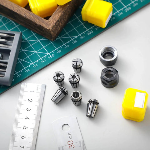 Pro Grade ER11 Spring Collet Set, 19-Piece CNC Milling Lathe Chuck Kit with collets and M14 nuts on a workbench