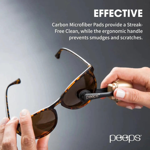 Person cleaning sunglasses with Peeps Eyeglass Lens Cleaner Carbon Microfiber NASA Safe Dry Clean