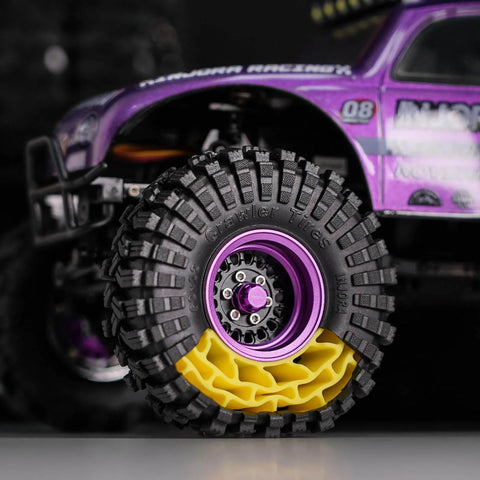 Close-up of silicone rubber inserts and S5 all-terrain tires for 1/18 TRX4M RC crawler with aggressive side lug grip