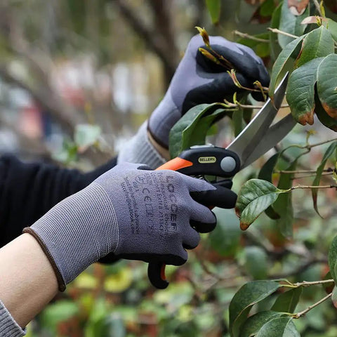 Person using MicroFoam Nitrile Coated Work Gloves 12 Pairs Size M Seamless Knit Nylon Grip for trimming plants