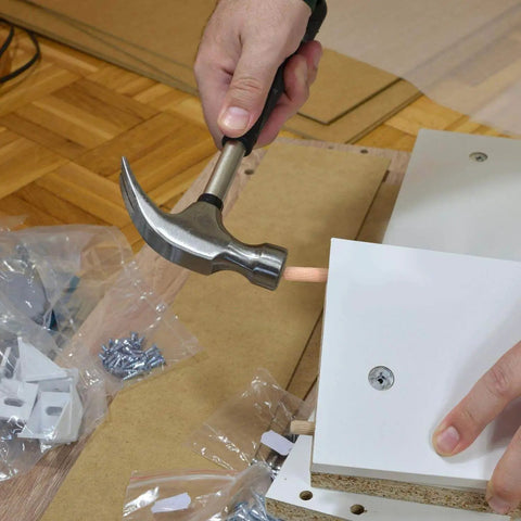 Person assembling furniture with One Thousand Hardwood Dowel Pins Set Three Eighths Inch By One And One Half Inch Fluted Dowel Rods