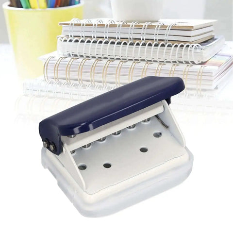 Six Hole Dope Handheld Metal Circle Paper Punch With Positioning Ruler for A4 A5 B5 notebooks on desk with spiral notebooks