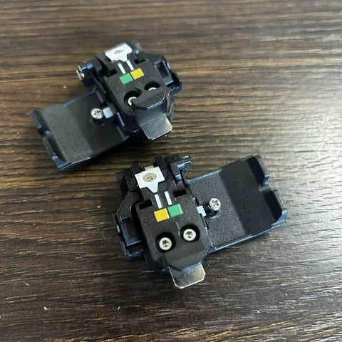 SP-03 Original Fiber Holder Chucking Jig for Fusion Splicer Clamps on wooden surface, compatible with FSM-90R to FSM-90S Series