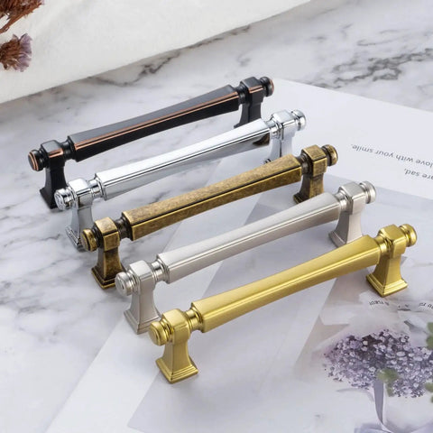 Assorted colored cabinet pulls displayed on a marble surface, showcasing 10 Pack 5 Inch Hole Centers Polished Chrome Cabinet Pulls