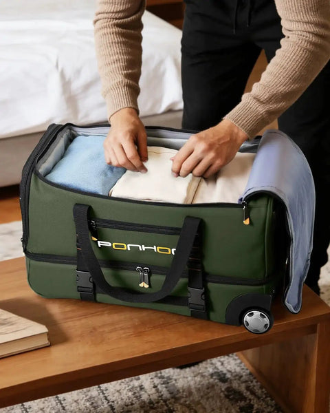 Person packing Rolling Duffle Bag With Wheels 21 Inch Travel Duffel With Shoe Compartment Water Resistant Wheeled Luggage in green