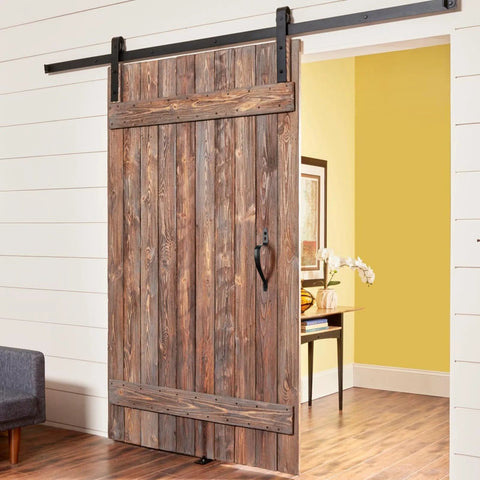 Wooden sliding door with Beefy 10 Inch Barn Door Handle Set, Black Metal Gate Pulls For Wooden Fences And Sheds, installed in a hallway