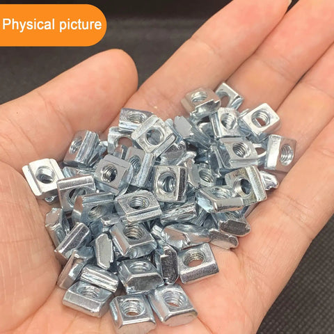 Hand holding 100 Pack 2020 Series Sliding T Nuts M5 Thread Hammer Head For 6mm T Slot Aluminum Extrusion Heavy Duty Steel Forging With Rustproof Plating