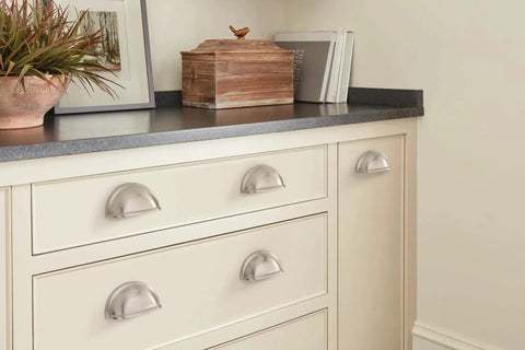 Traditional Cup Pull Cabinet Handle in Satin Nickel, 3 Inch Center-to-Center, installed on white drawers in modern kitchen setting.