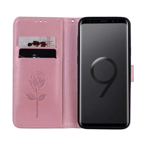 Pink floral smartphone wallet case with card slots open to reveal phone
