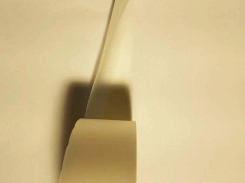 Close-up of Two Inch By Zero Point Zero One Five Inch By One Hundred Foot Urethane Die Protection Film for press brake jobs.