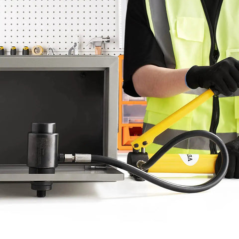 Worker demonstrating 10 Ton Hydraulic Knockout Punch Kit With Half Inch To Two Inch Conduit Die Set Puncher Six Dies Step Drill Bit Carrying