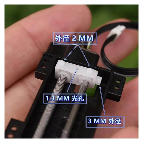 Close-up of tiny 6mm precision planetary stepper motor with micro 2 phase 4 wire stepping, showing detailed measurements in use.