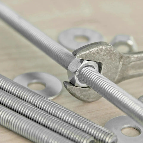 Wrench tightening nut on M6 25mm 304 Stainless Steel Fully Threaded Rods 8 Pcs Right Hand Thread on wooden surface