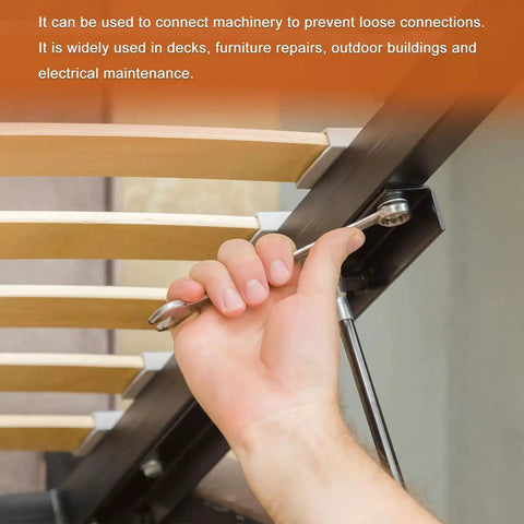 Person using wrench to tighten bolts on a metal bed frame showcasing bolt installation and adjustment process.