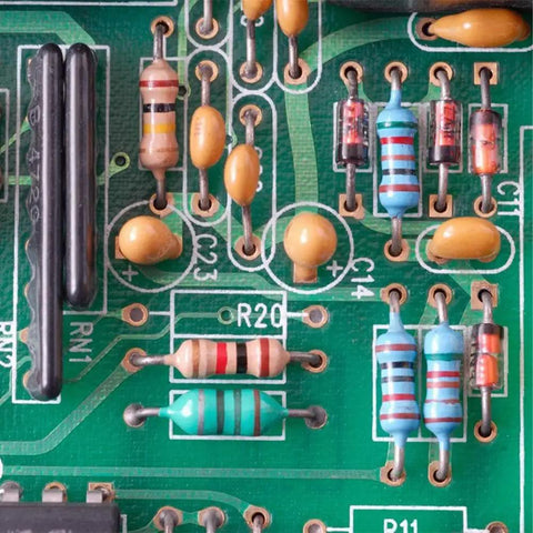 Resistors on a green PCB; assorted carbon-film, 1/4W, 5% tolerance in various colors.
