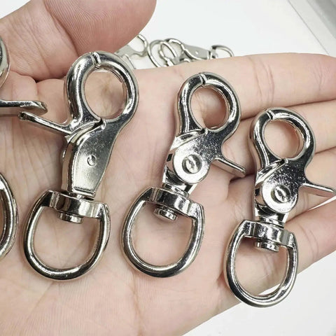 Close-up of Lobster Clasp Trigger Snap Hooks 360 Degree Swivel Zinc Alloy 30 Pack held in a hand, showing metal finish and swivel function.