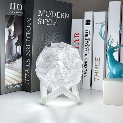 Crystal Clear PETG Filament 1.75mm 1kg For 3D Printing, glasslike lampshade on a shelf with books and decor