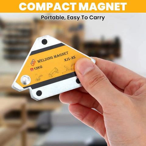Hand holding a compact magnetic welder with label showing 13kg capacity, suitable for welding and assembling applications.