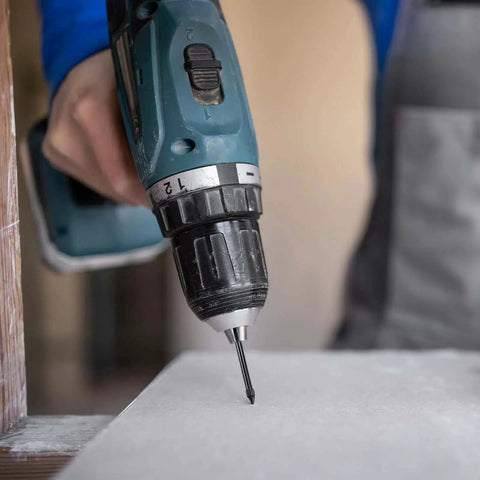 Close-up of a drill using the Five Piece Dry Diamond Drill Bit Set For Masonry And Tile With 6mm Core Bits on a tile surface.