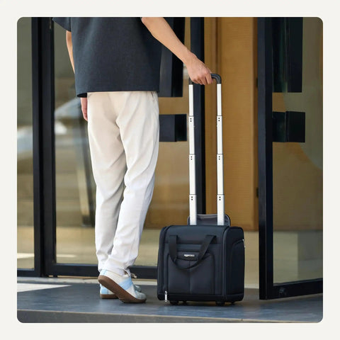 Person with Underseat Carry On Luggage With Smooth Wheels And Sturdy Handle 14 Inch Rolling Travel Bag at entrance