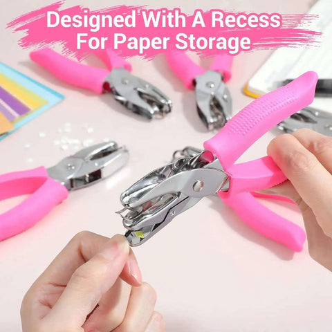 Close-up of Six Piece Craft Hole Punch Set with pink soft grip handles, showing handheld punch creating paper shape.
