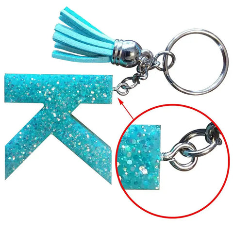 Close-up of a teal glittery resin charm with mini screw eye pin from 300Pcs Mini Screw Eye Pins and Hooks Set 10x5mm SelfTapping Screws.
