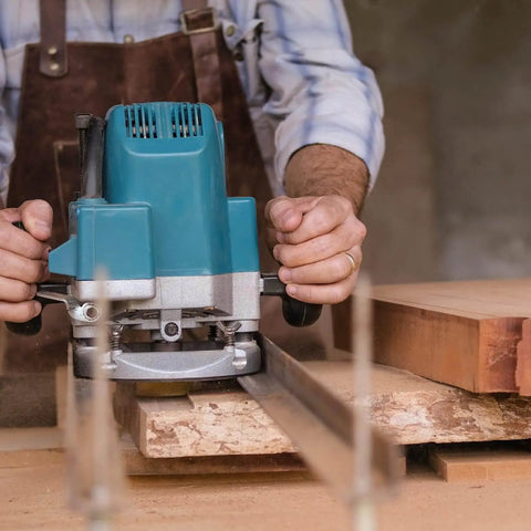 Carpenter using a Slab Flattening Router Bit, One Quarter Inch Shank, Two Inch Diameter, One Half Inch Cutting Depth on wood