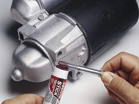 Applying Red High Strength Threadlocker Stick For Automotive And Industrial Bolts 9 Gram Loctite 37701 to a threaded bolt