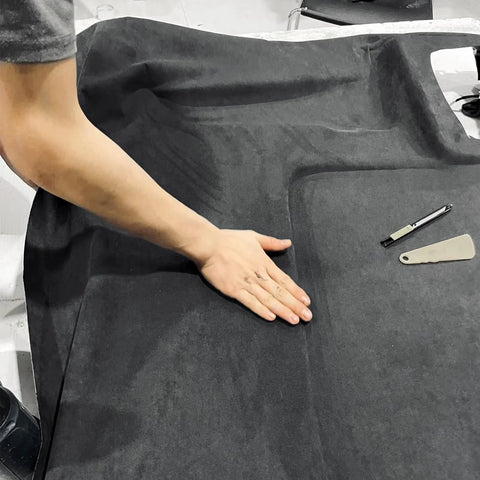 Person working on Suede Auto Headliner Fabric 120 By 60 Inches With Foam Backing Black Interior, installing in a car.