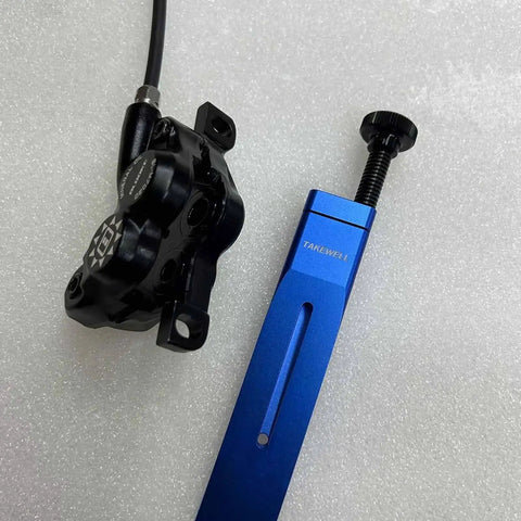 Blue aluminum Piston Press Tool for Brake Calipers with bicycle hydraulic brake caliper, compatible with Shimano and SRAM