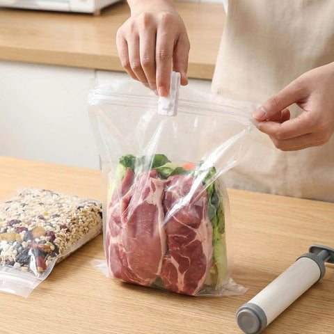 Person sealing meat in vacuum bag using 30 Piece Vacuum Storage Bags Sealing Clip Reusable Zipper Labor Saver Sliding Grip For Clothes Bedding And Food Preservation Airtight Seal Clips For Quick Access And Snack Bags Hassle Free Easy Pack And Unseal.