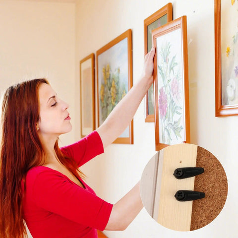 Woman hanging frame using 50 Pcs Picture Frame Backing Clips With Screws Black Turn Button Hardware For Hanging Photos Artwork Gift Boxes