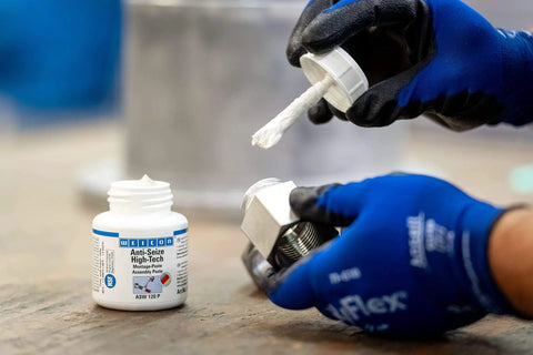 Anti Seize High Tech Metal Free Assembly Paste being applied to metal threads, NSF certified, for stainless steel and food equipment, 4.2 oz.