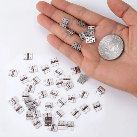 Miniature Jewelry Box Hinges for Crafts 20 Sets Metal Butt Hinges 10.3x8.1mm with Screws shown in a hand with a coin for scale
