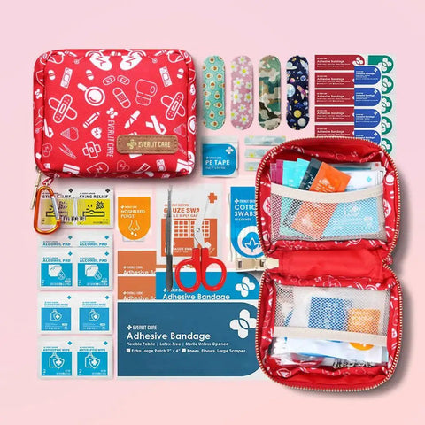 Open Pocket Size 105-Piece First Aid Kit for Families and Kids, showcasing bandages, scissors, and medical supplies, red portable storage bag.