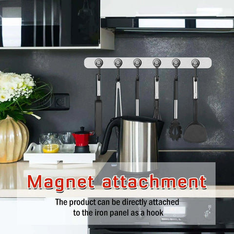 Magnetic utensil holder with hooks attached to kitchen wall above stove.